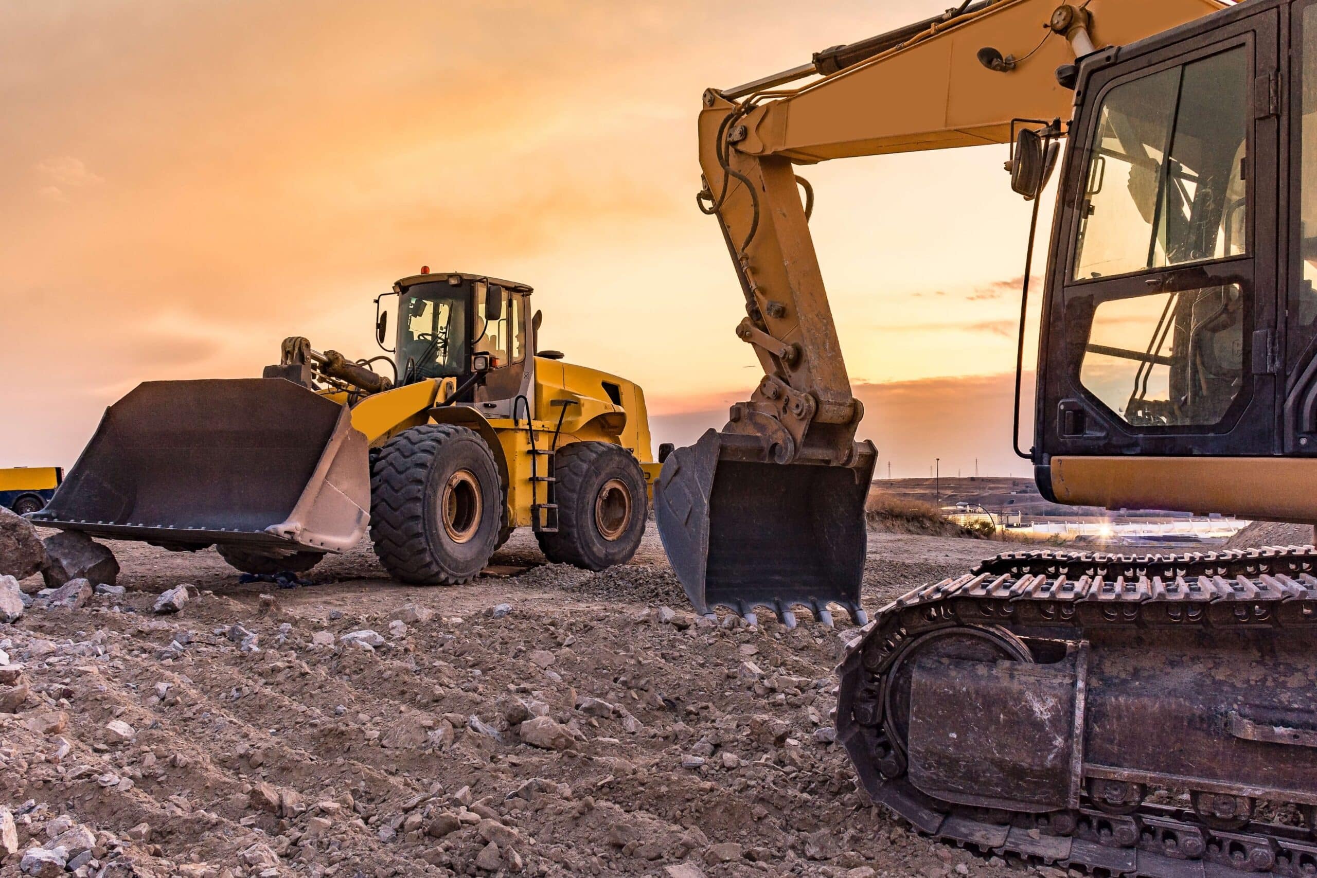 equipment-parking Construction equipment parking area with loaders and excavators at sunset